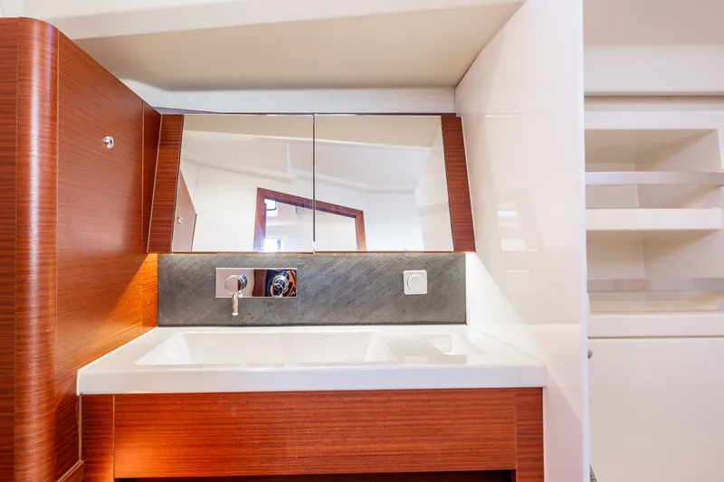 Dragon Fly Yacht Photos Pics Modern bathroom vanity in 2019 Hanse 418 yacht, featuring sleek wood and mirrored design.