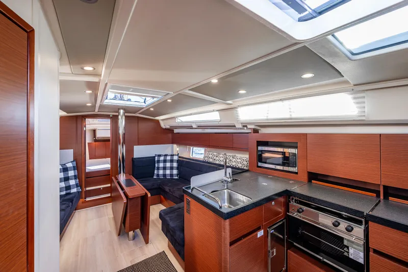 Dragon Fly Yacht Photos Pics Luxurious interior of 2019 Hanse 418 yacht with modern kitchen and seating area.