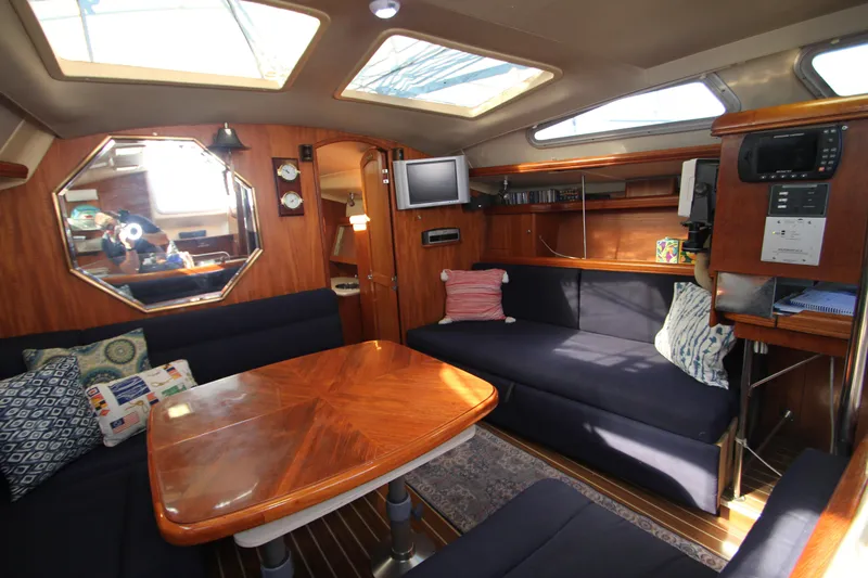 Solimar Yacht Photos Pics Interior of 2005 Hunter 41 AC yacht with wooden furnishings and cozy seating area.