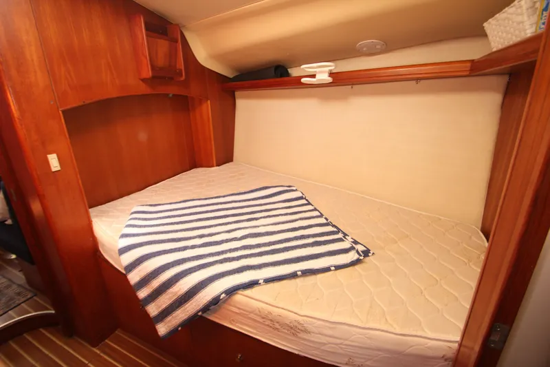 Solimar Yacht Photos Pics Cozy cabin bed in 2005 Hunter 41 AC sailboat with striped blanket.