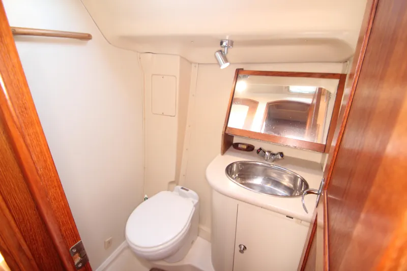 Solimar Yacht Photos Pics Compact bathroom in 2005 Hunter 41 AC yacht with sink, toilet, and mirror.