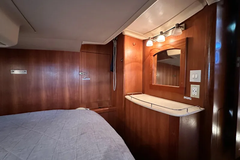 Solimar Yacht Photos Pics Cozy cabin interior of 2005 Hunter 41 AC sailboat with wooden finish and mirror.