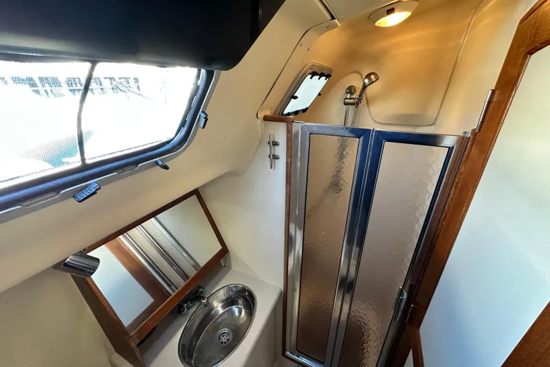Solimar Yacht Photos Pics Compact bathroom in 2005 Hunter 41 AC yacht with shower, sink, and window.
