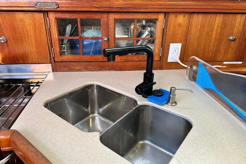 Solimar Yacht Photos Pics Galley sink area in 2005 Hunter 41 AC sailboat with wooden cabinetry.