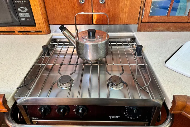 Solimar Yacht Photos Pics Stainless steel stove with kettle in a 2005 Hunter 41 AC yacht kitchen.