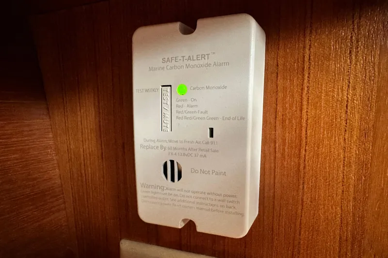 Solimar Yacht Photos Pics Carbon monoxide alarm on 2005 Hunter 41 AC boat, mounted on wooden panel.