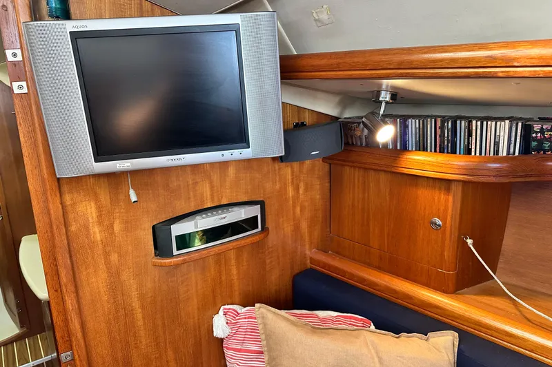 Solimar Yacht Photos Pics Interior of 2005 Hunter 41 AC yacht with TV, sound system, and wooden cabinetry.