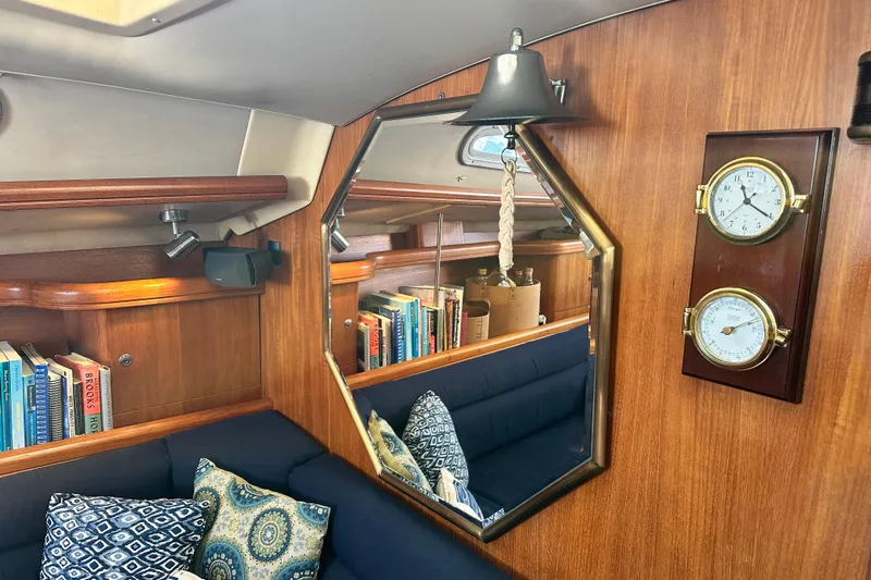 Solimar Yacht Photos Pics Interior of 2005 Hunter 41 AC sailboat with books, mirror, and nautical decor.