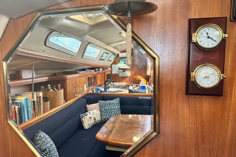 Solimar Yacht Photos Pics Interior of 2005 Hunter 41 AC sailboat with cozy seating and nautical decor.