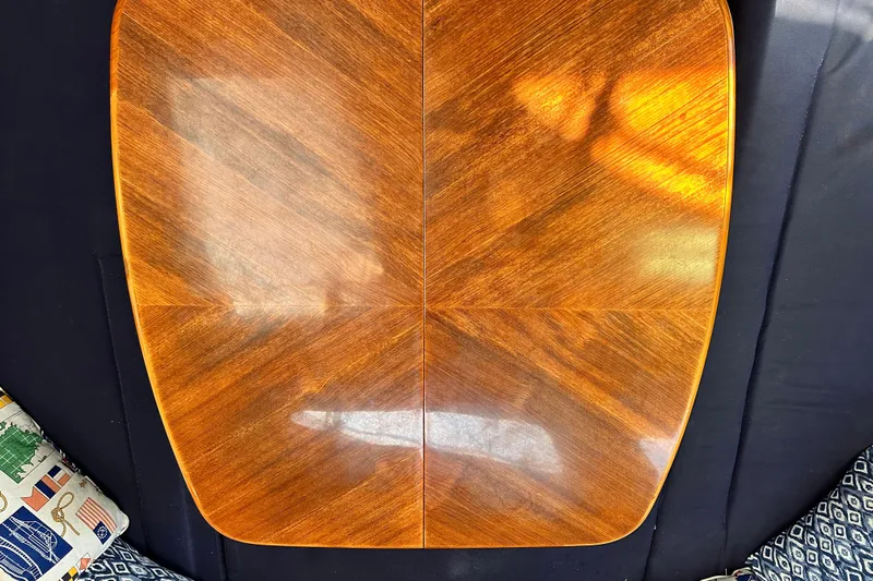 Solimar Yacht Photos Pics Polished wooden table on a Hunter 41 AC, 2005 model, with patterned cushions.