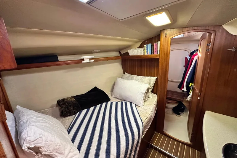 Solimar Yacht Photos Pics Cozy cabin interior of 2005 Hunter 41 AC sailboat with bed and wooden accents.