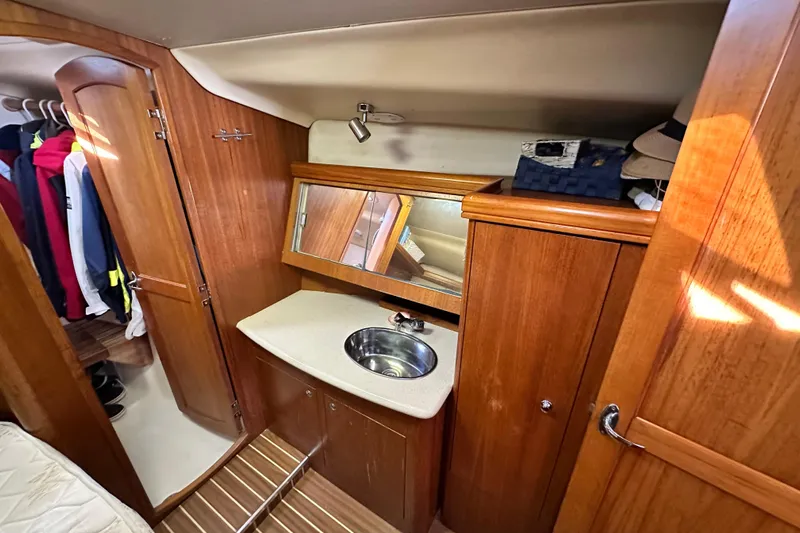 Solimar Yacht Photos Pics 2005 Hunter 41 AC yacht interior with wooden cabinetry and compact sink area.