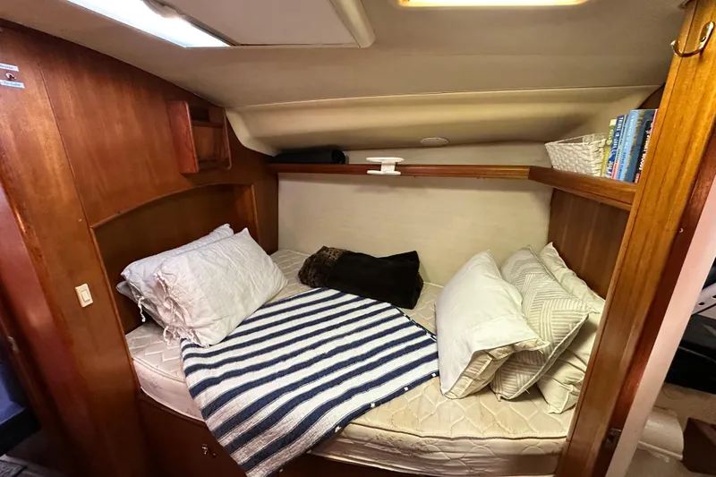 Solimar Yacht Photos Pics Cozy cabin interior of 2005 Hunter 41 AC sailboat with bed and pillows.