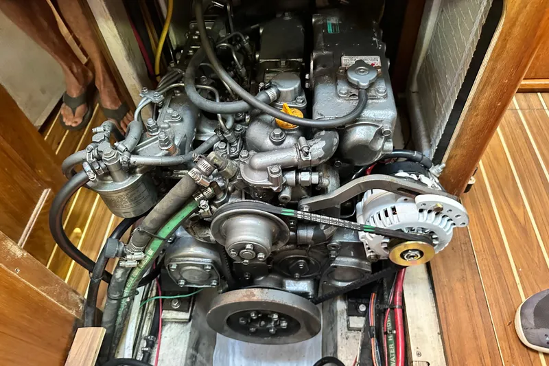 Solimar Yacht Photos Pics Engine compartment of a 2005 Hunter 41 AC sailboat, showcasing mechanical components and alternator.