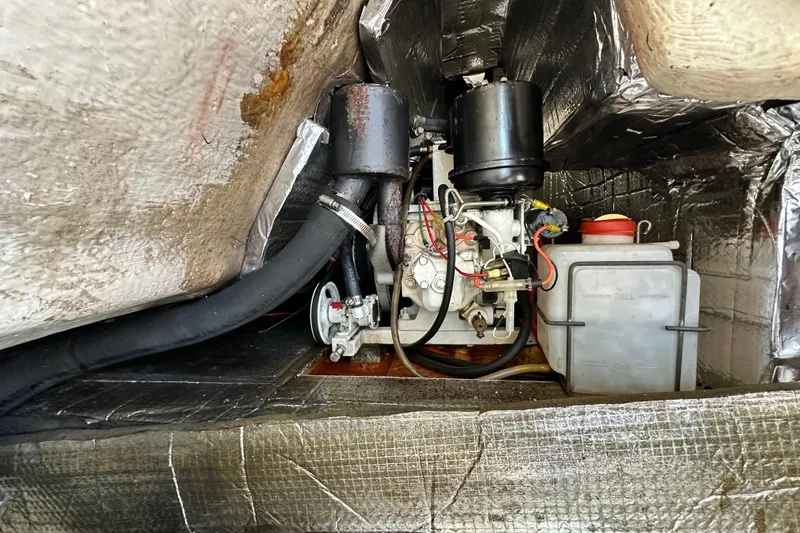 Solimar Yacht Photos Pics Engine compartment of a 2005 Hunter 41 AC sailboat, featuring mechanical components and wiring.