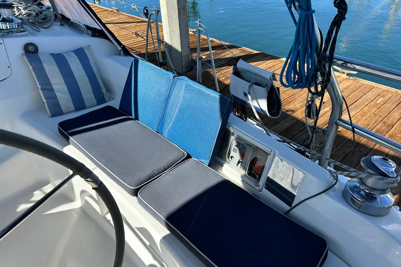 Solimar Yacht Photos Pics Cockpit of 2005 Hunter 41 AC sailboat with blue cushions and striped pillow.