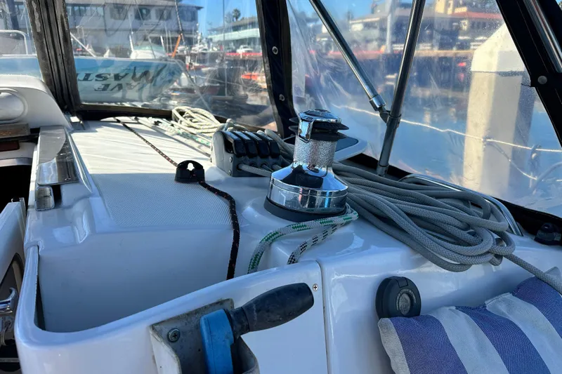 Solimar Yacht Photos Pics Cockpit of 2005 Hunter 41 AC sailboat with winch, ropes, and striped cushion.