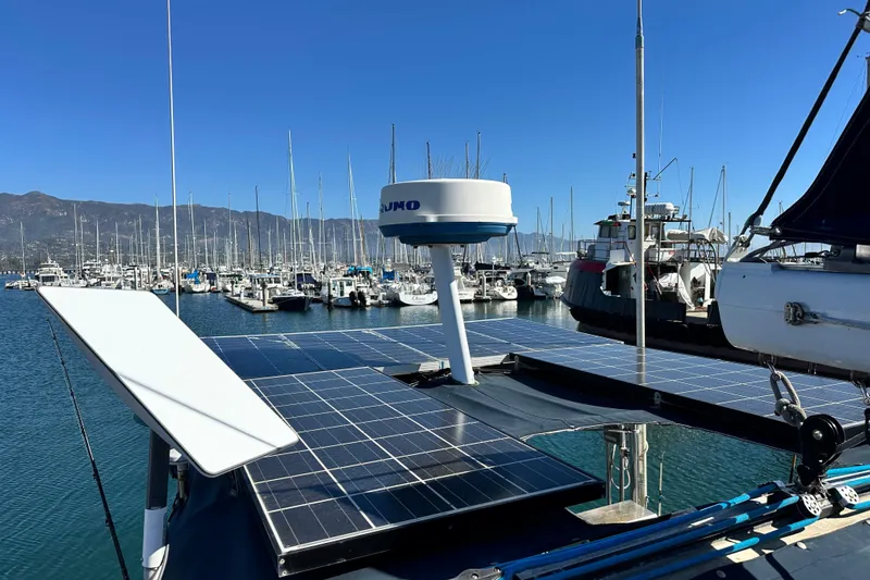 Solimar Yacht Photos Pics Hunter 41 AC 2005 sailboat with solar panels docked in a marina, surrounded by other boats.