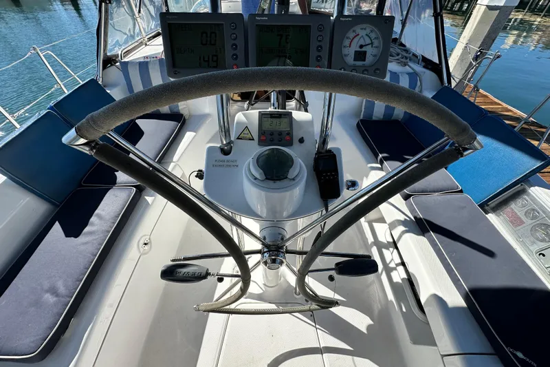 Solimar Yacht Photos Pics Steering wheel and cockpit of 2005 Hunter 41 AC sailboat with navigation instruments.