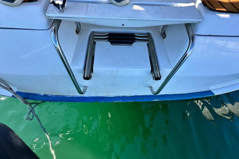 Solimar Yacht Photos Pics Rear view of a 2005 Hunter 41 AC boat with a swim ladder.