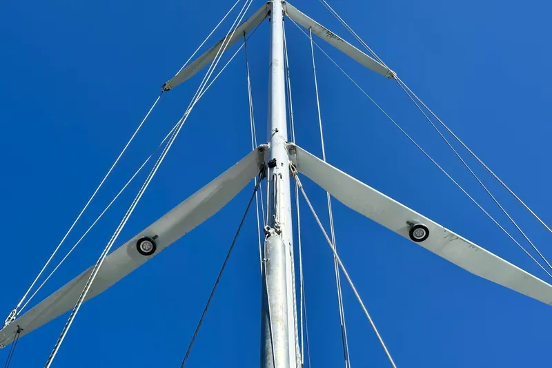 Solimar Yacht Photos Pics Mast of 2005 Hunter 41 AC sailboat against clear blue sky.