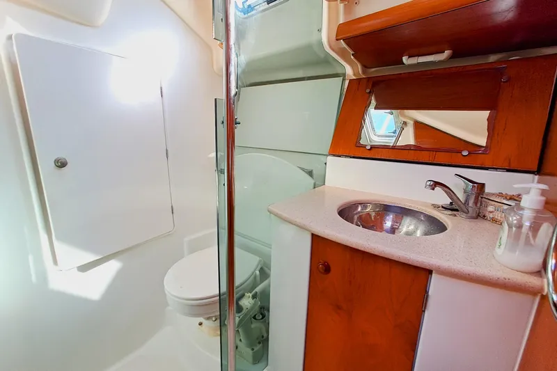  Yacht Photos Pics 2005 Jeanneau Sun Odyssey 40.3 yacht bathroom with sink, mirror, and toilet.