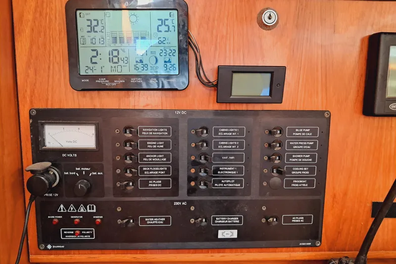  Yacht Photos Pics Control panel of a 2005 Jeanneau Sun Odyssey 40.3 sailboat with various switches and displays.