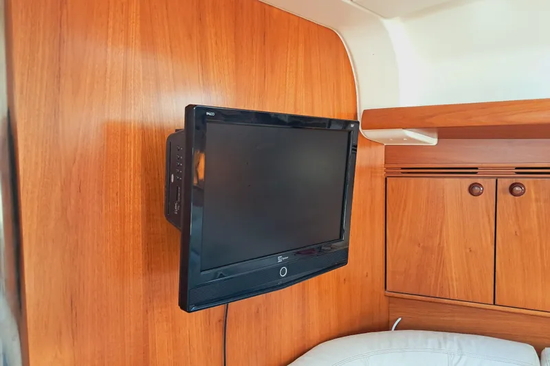  Yacht Photos Pics Flat-screen TV mounted on wooden interior of 2005 Jeanneau Sun Odyssey 40.3 yacht.
