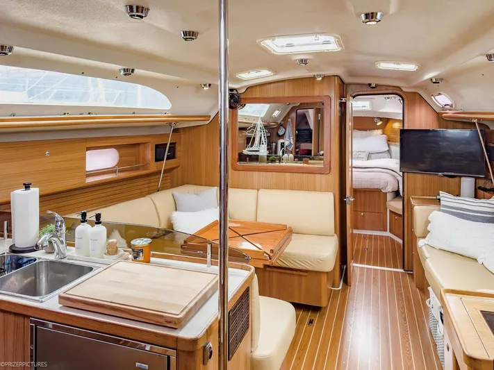 Kinship Ll Yacht Photos Pics Luxurious interior of 2010 Catalina 445 yacht with modern kitchen and cozy seating area.
