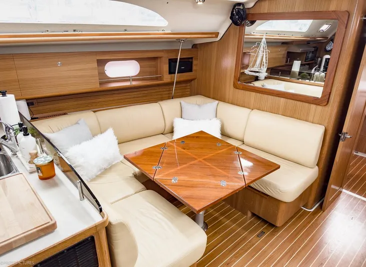 Kinship Ll Yacht Photos Pics Luxurious interior of 2010 Catalina 445 yacht with beige seating and wooden accents.