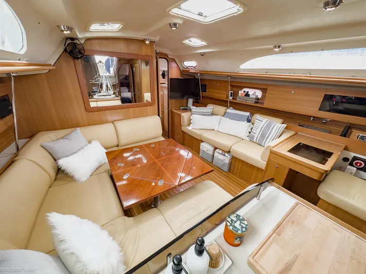 Kinship Ll Yacht Photos Pics Luxurious interior of a 2010 Catalina 445 yacht with plush seating and wooden accents.