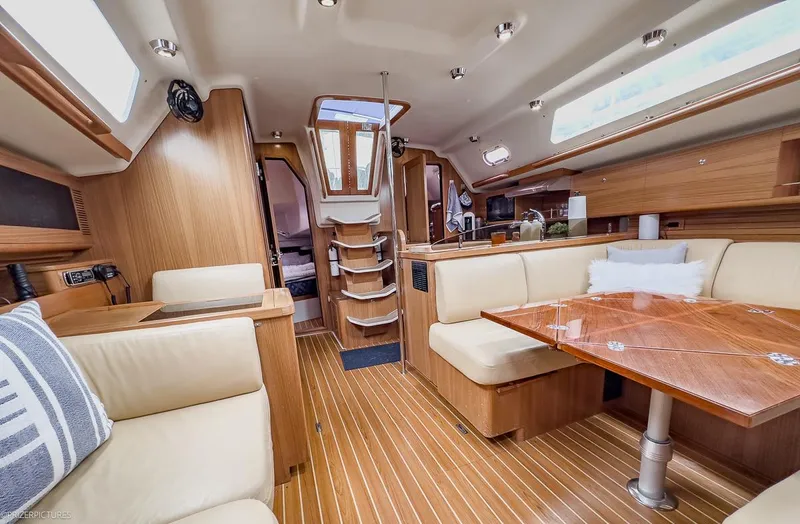 Kinship Ll Yacht Photos Pics Interior of 2010 Catalina 445 yacht with wooden finishes and cozy seating area.