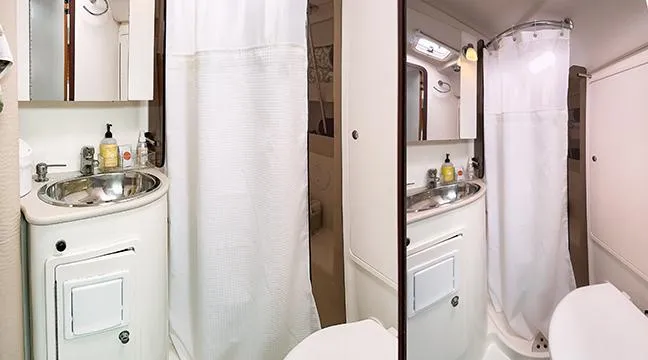 Kinship Ll Yacht Photos Pics Compact bathroom in a 2010 Catalina 445 yacht, featuring a sink, mirror, and shower.