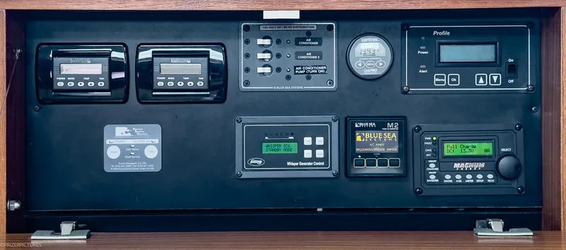 Kinship Ll Yacht Photos Pics Control panel of a 2010 Catalina 445 sailboat with various electronic displays and switches.