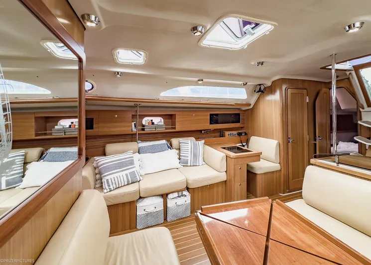 Kinship Ll Yacht Photos Pics Luxurious interior of a 2010 Catalina 445 yacht with plush seating and wooden finishes.