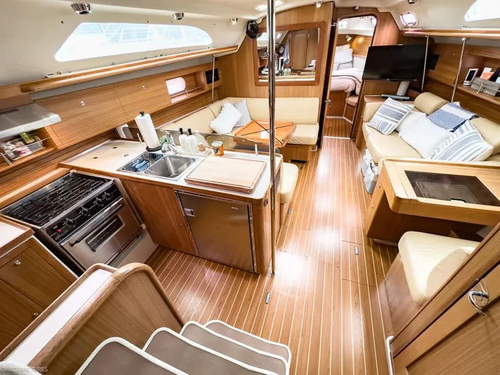 Kinship Ll Yacht Photos Pics Interior of 2010 Catalina 445 yacht with modern kitchen and cozy seating area.