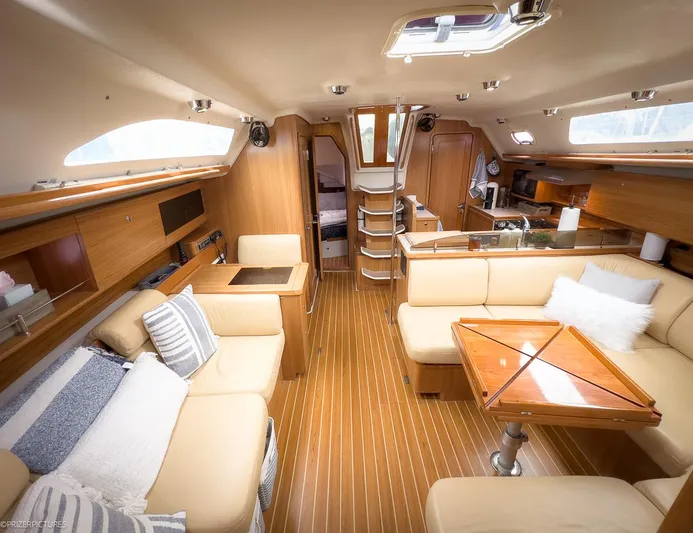 Kinship Ll Yacht Photos Pics Interior of 2010 Catalina 445 yacht with elegant wood finish and cozy seating area.