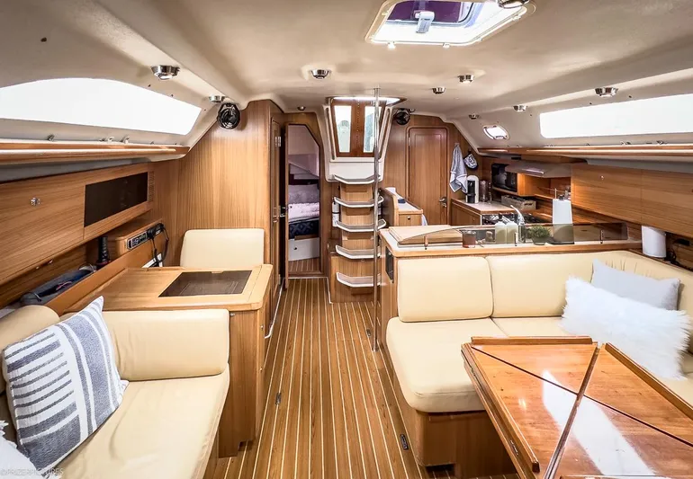 Kinship Ll Yacht Photos Pics Interior of 2010 Catalina 445 yacht with wooden finish and cozy seating area.