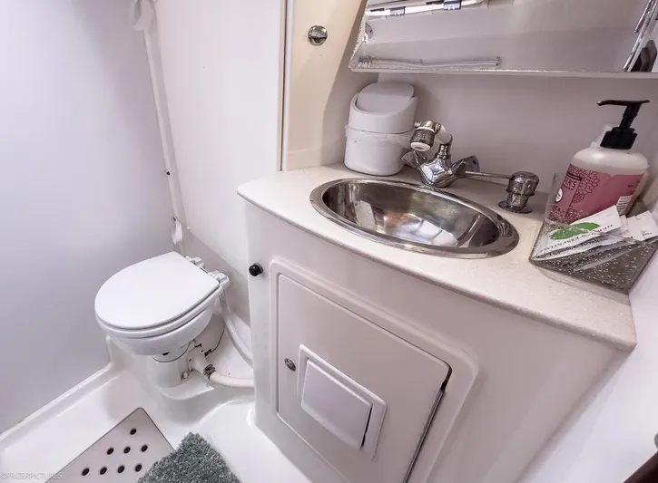 Kinship Ll Yacht Photos Pics Compact bathroom in a 2010 Catalina 445 yacht with toilet and sink.