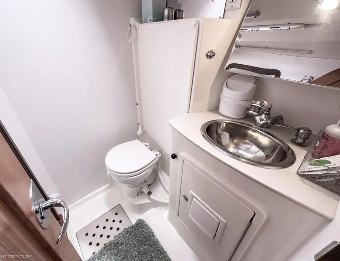 Kinship Ll Yacht Photos Pics Compact bathroom in a 2010 Catalina 445 yacht, featuring a toilet and stainless steel sink.
