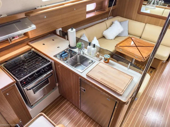 Kinship Ll Yacht Photos Pics Interior of 2010 Catalina 445 yacht with modern kitchen and cozy seating area.