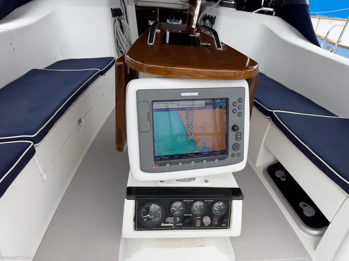 Kinship Ll Yacht Photos Pics Cockpit of 2010 Catalina 445 sailboat with navigation system and cushioned seating.