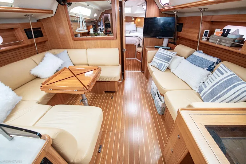Kinship Ll Yacht Photos Pics Luxurious interior of 2010 Catalina 445 yacht with cozy seating and elegant wood finishes.