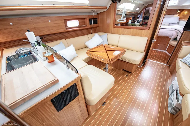 Kinship Ll Yacht Photos Pics Luxurious interior of 2010 Catalina 445 yacht with cozy seating and modern kitchen area.