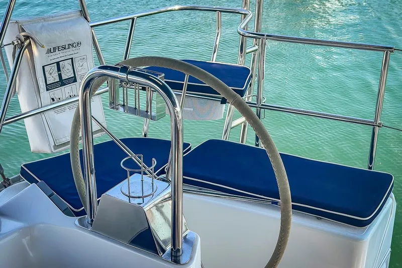 Kinship Ll Yacht Photos Pics Steering wheel and seating on a 2010 Catalina 445 sailboat, with lifesaving equipment.