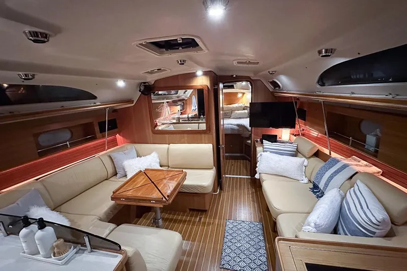 Kinship Ll Yacht Photos Pics Luxurious interior of a 2010 Catalina 445 yacht with cozy seating and elegant decor.