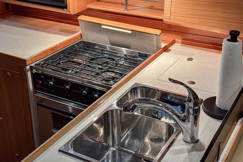 Kinship Ll Yacht Photos Pics Modern kitchen in 2010 Catalina 445 yacht with stove, sink, and paper towel holder.