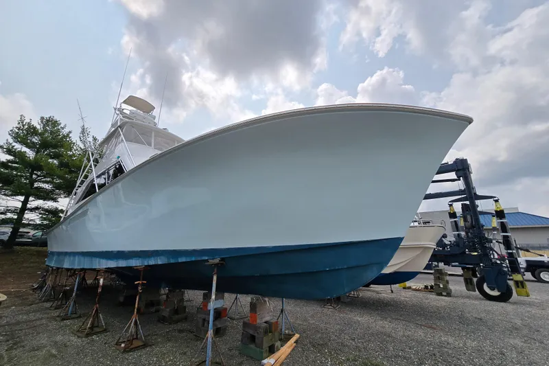  Yacht Photos Pics 1986 Ocean Yachts 55 Super Sport boat on stands under cloudy sky.