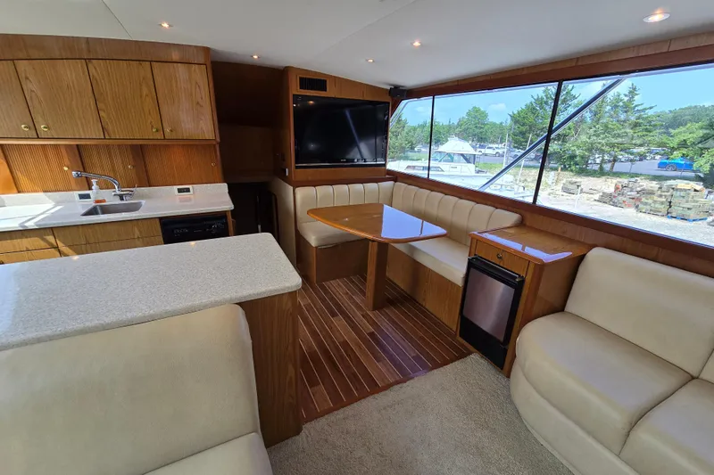  Yacht Photos Pics Interior of 1986 Ocean Yachts 55 Super Sport with kitchen and seating area.