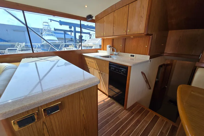  Yacht Photos Pics 1986 Ocean Yachts 55 Super Sport interior with wooden cabinetry and modern kitchen amenities.